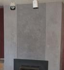 Trowelable overlay was used to fill the grout lines and smooth over the existing bricks on this fireplace/chimney.  Several, thin layers of pigmented cement micro-topping were then troweled over all areas to give it the look of a large concrete column..